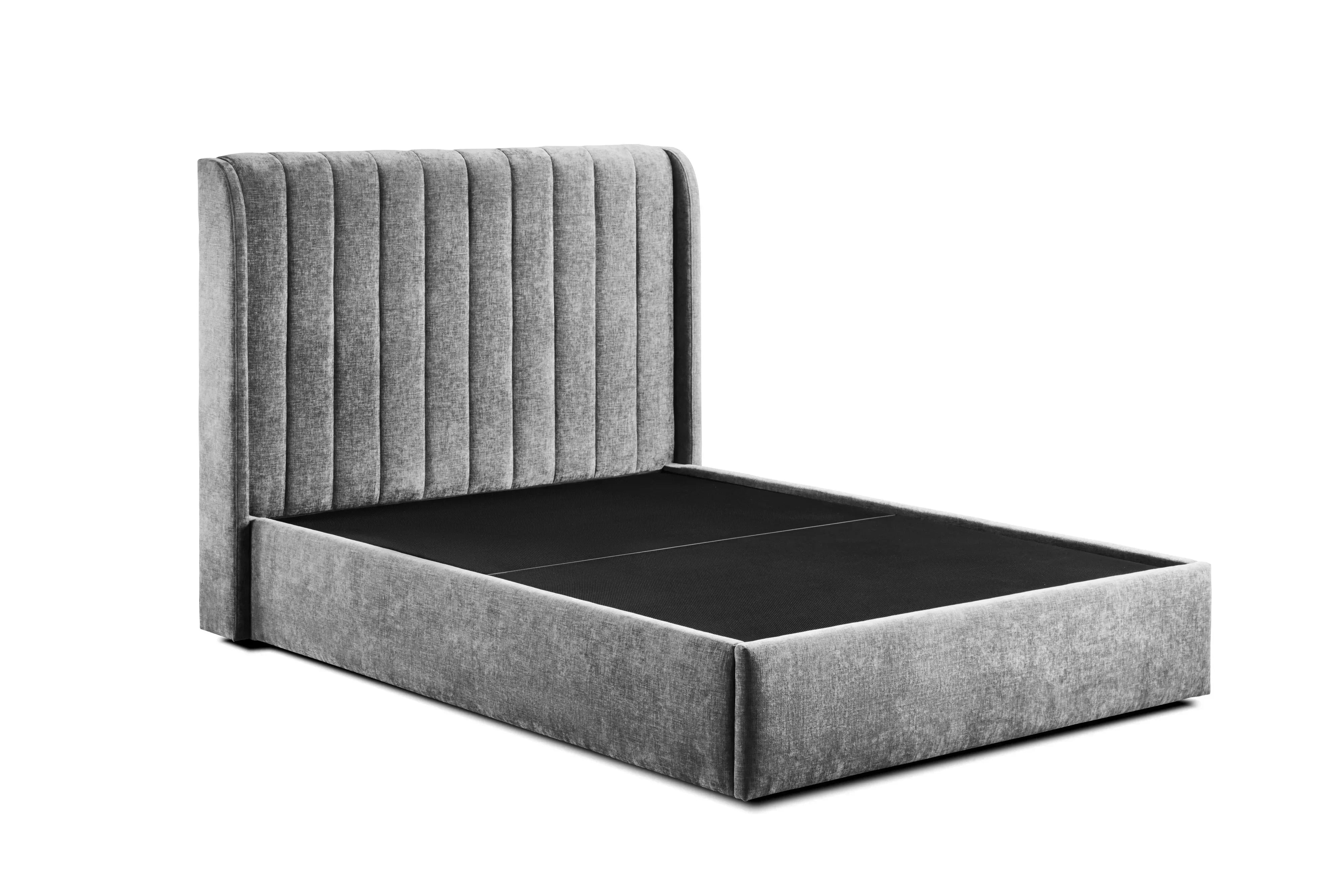 Grey fabric bed frame with vertical panel headboard and low footboard, angled side view