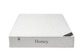White honey mattress with quilted pattern and side label, front angle view