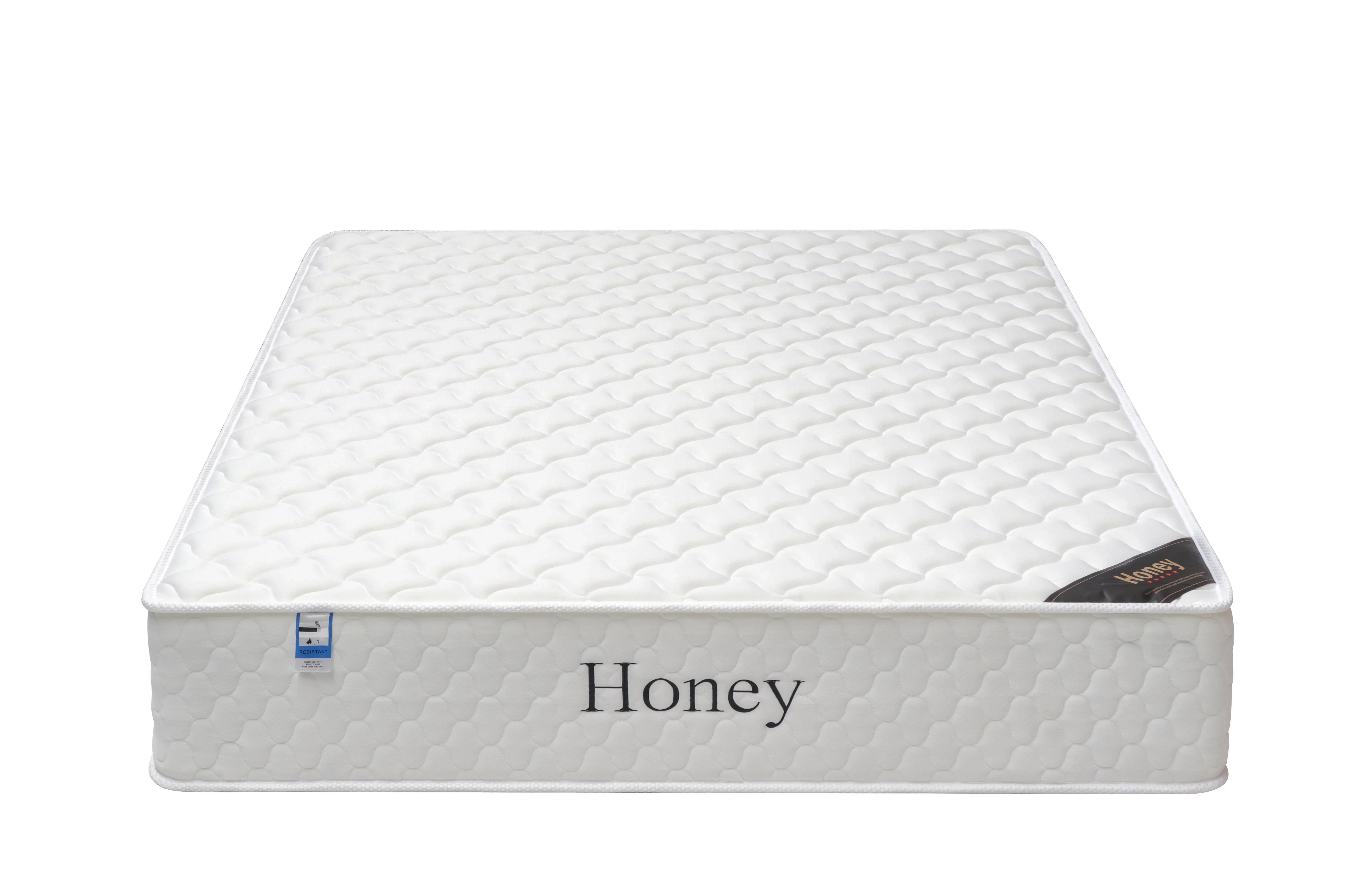 White honey mattress with quilted pattern and side label, front angle view