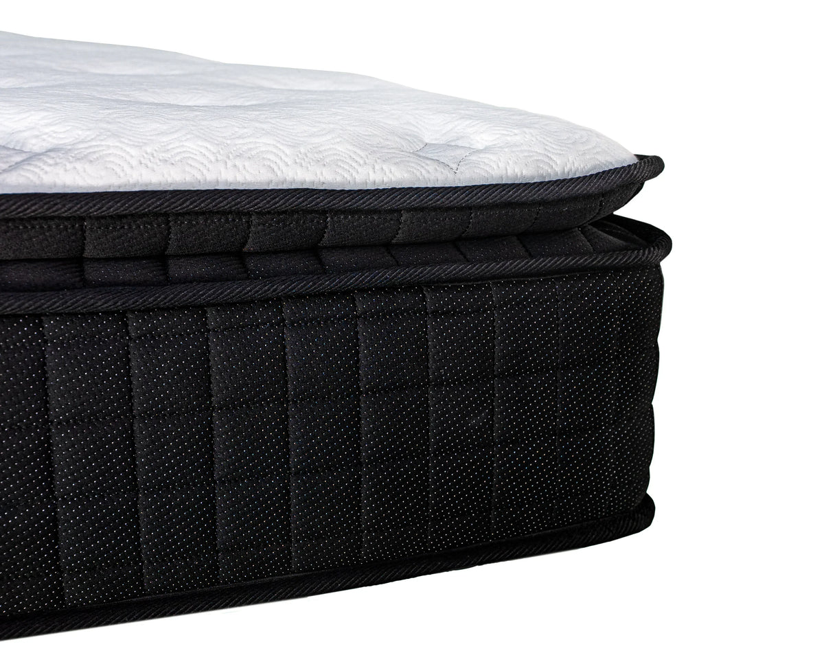 Side view of black mattress with white quilted pillow top and stitched detailing