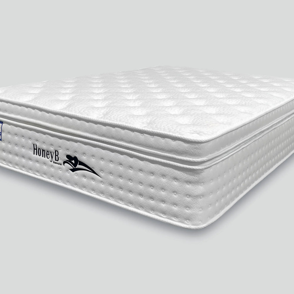 white mattress with quilted top and side logo in showroom style setting
