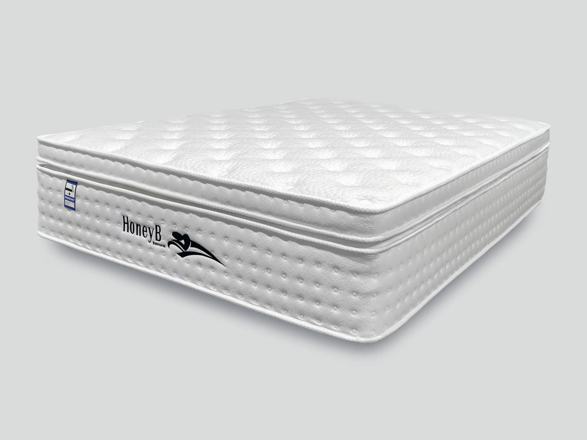 white mattress with quilted top and side logo in showroom style setting