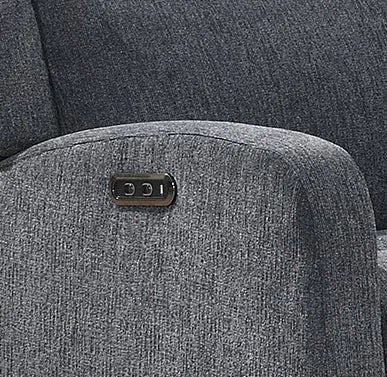 Close-up of a dark gray textured fabric armrest with a small black control panel featuring white buttons.