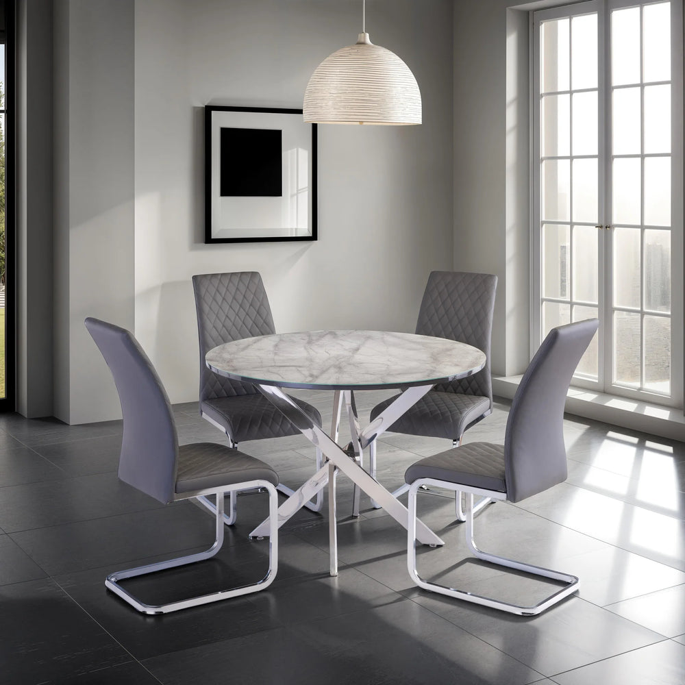 Modern dining room with a round marble table and gray chairs.