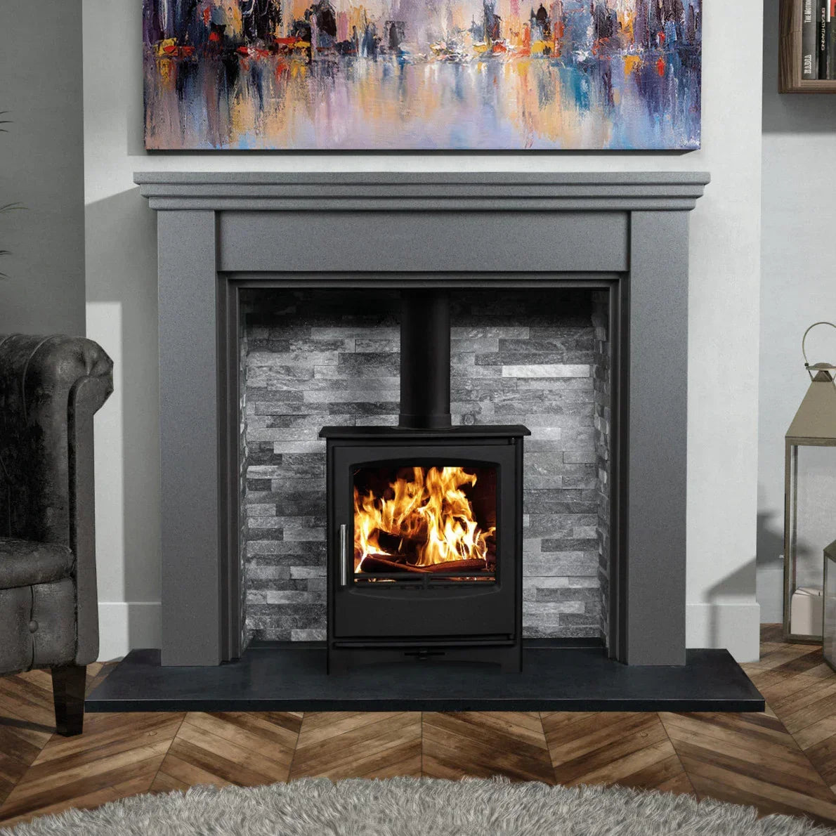 Polished luna grey fireplace surround with wood burning stove on herringbone wood floor
