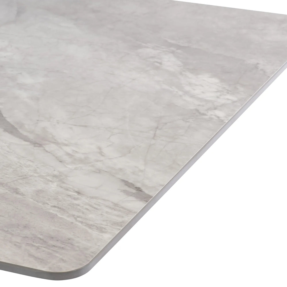 A close-up of a rectangular mat or tray with rounded corners, featuring a light gray and white marble pattern, shown against a plain white background.