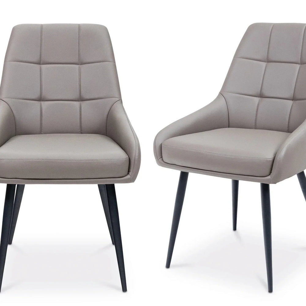 Pair of grey dining chairs with padded upholstery and black legs on white background
