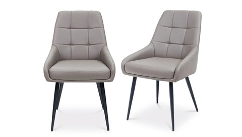 Pair of grey dining chairs with padded upholstery and black legs on white background