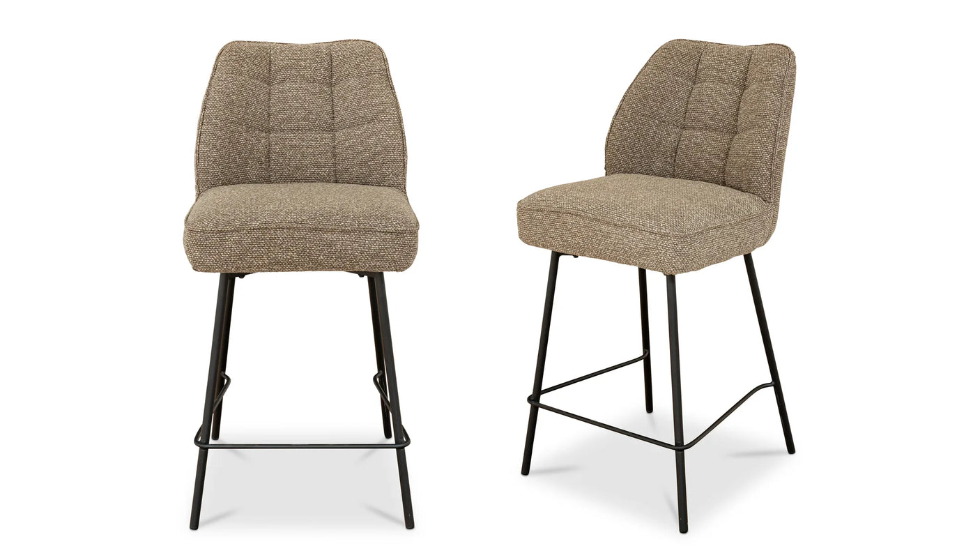 Two brown bar stools with quilted seats on a white background