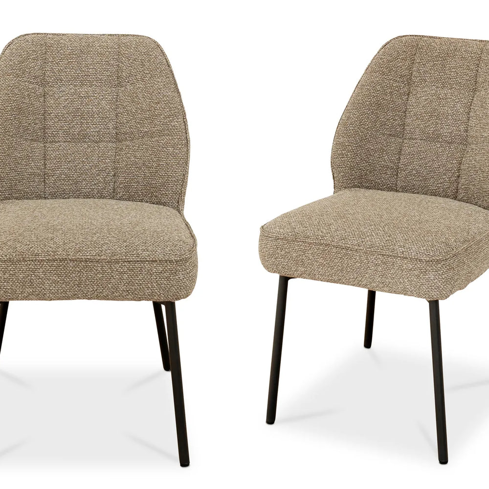 Two beige upholstered chairs with black legs on a white background