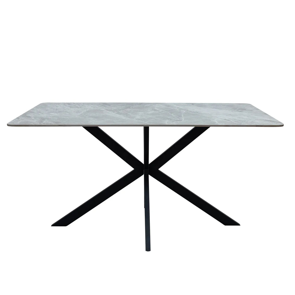 A rectangular dining table with a light gray marble-patterned top and a black metal X-shaped base, shown against a plain white background.