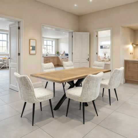 A modern dining room scene featuring a rectangular wooden dining table with a black metal X-base, surrounded by six upholstered dining chairs in a light beige textured fabric with black legs.