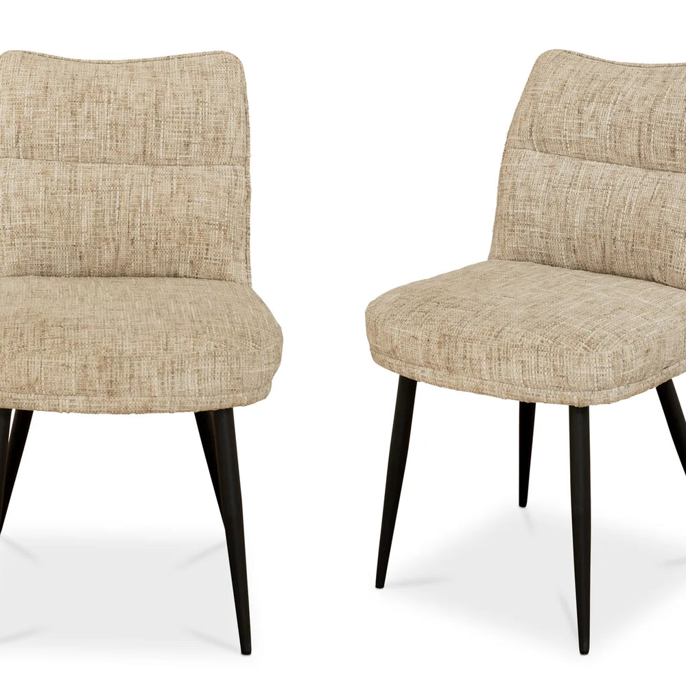 Two upholstered dining chairs with textured beige fabric seats and backs and black tapered legs, shown on a clean white background.