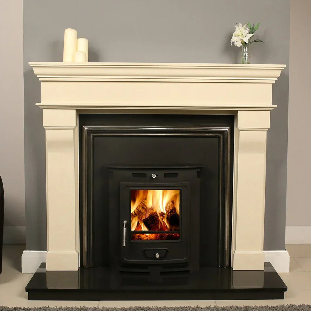 Cream fireplace surround with wood burning stove set against grey wall, black hearth