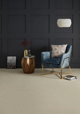 Blue velvet armchair with gold frame in modern room, styled with geometric side table and