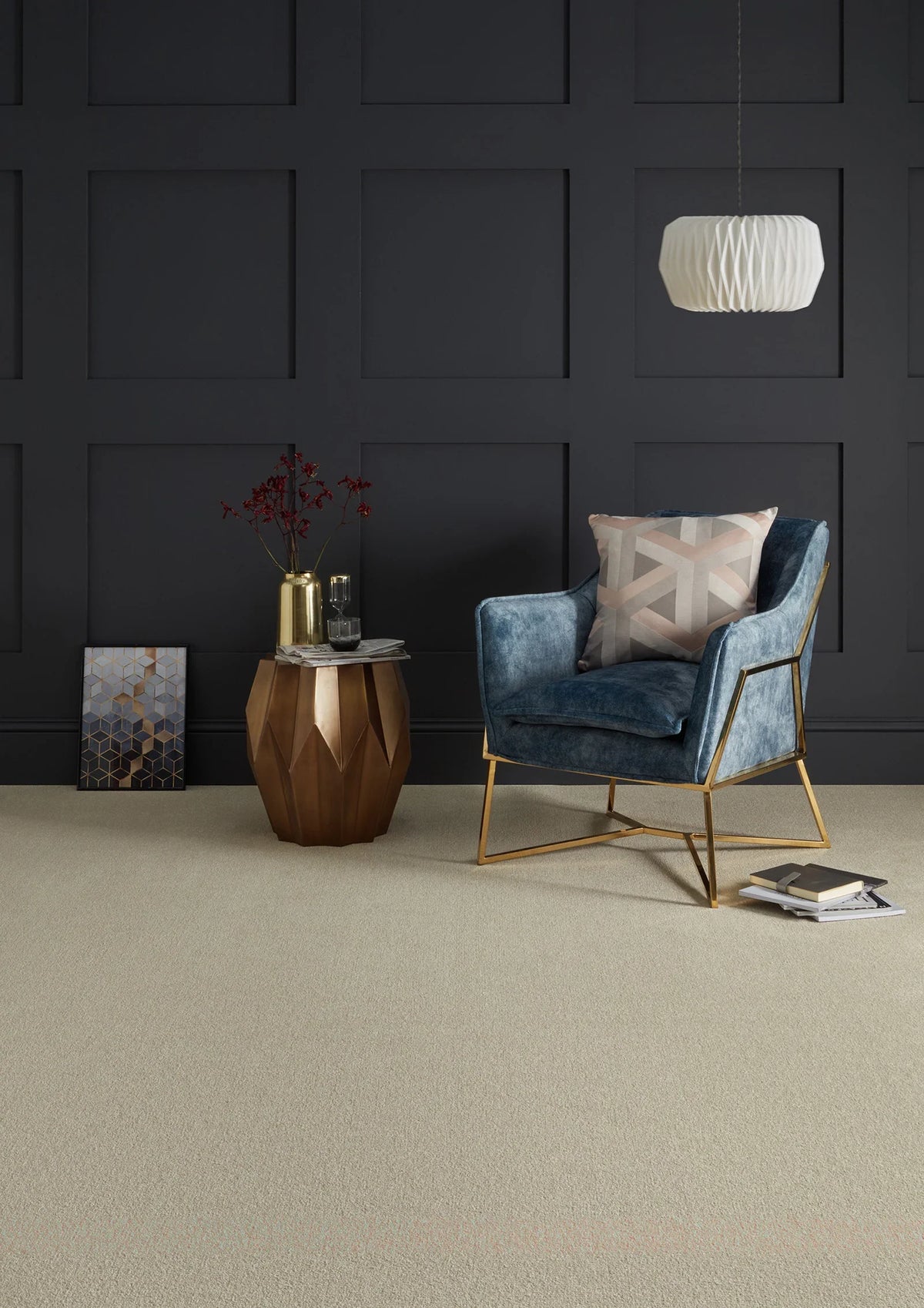 Blue velvet armchair with gold frame in modern room, styled with geometric side table and