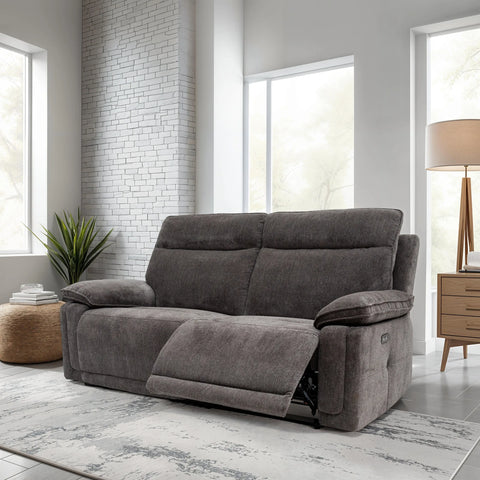 Gray sofa in a modern living room with white brick wall and large windows.