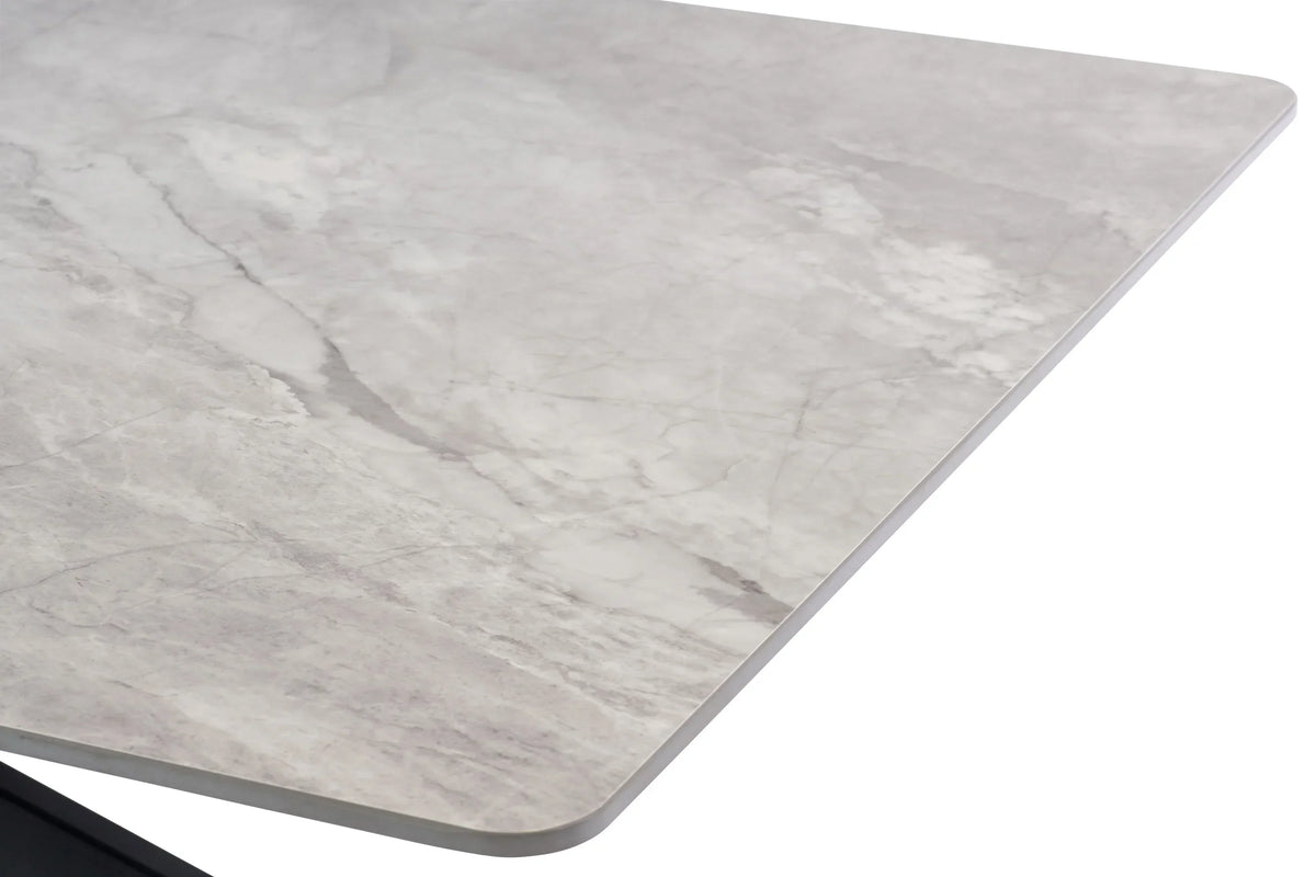 Close up of grey marble effect dining table corner with smooth rounded edge