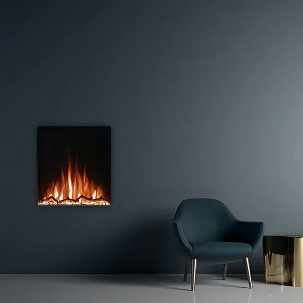 Wall-mounted electric fireplace with flames beside a dark blue armchair and gold side table