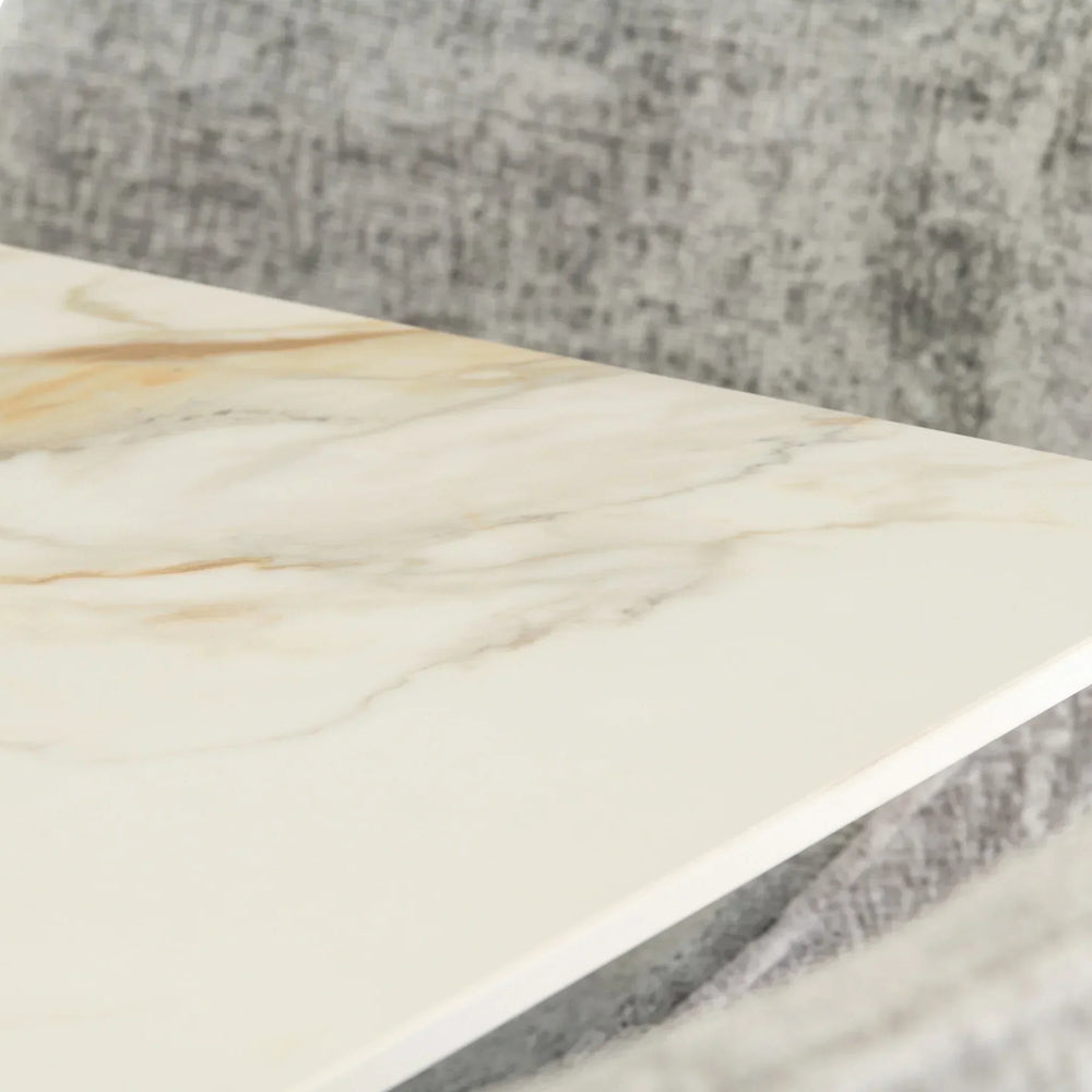 Close up of marble dining table top with grey fabric chair in background