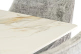 Close up of marble dining table top with grey fabric chair in background