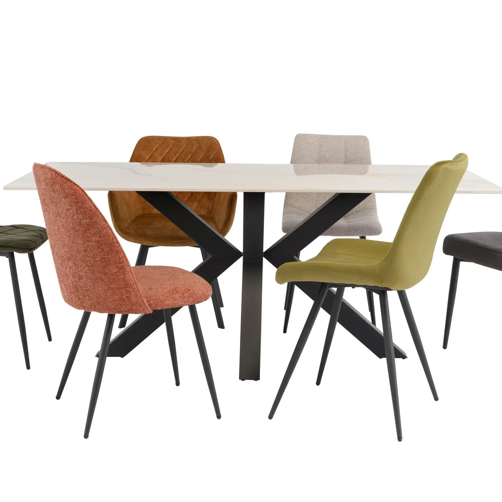 Modern dining table with black metal legs and six mixed color fabric dining chairs