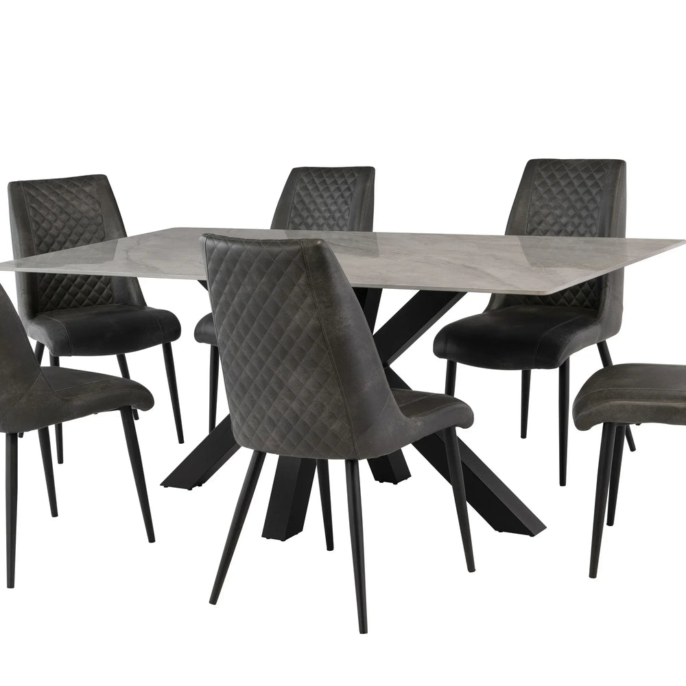 Modern marble dining table with black legs and six grey quilted dining chairs