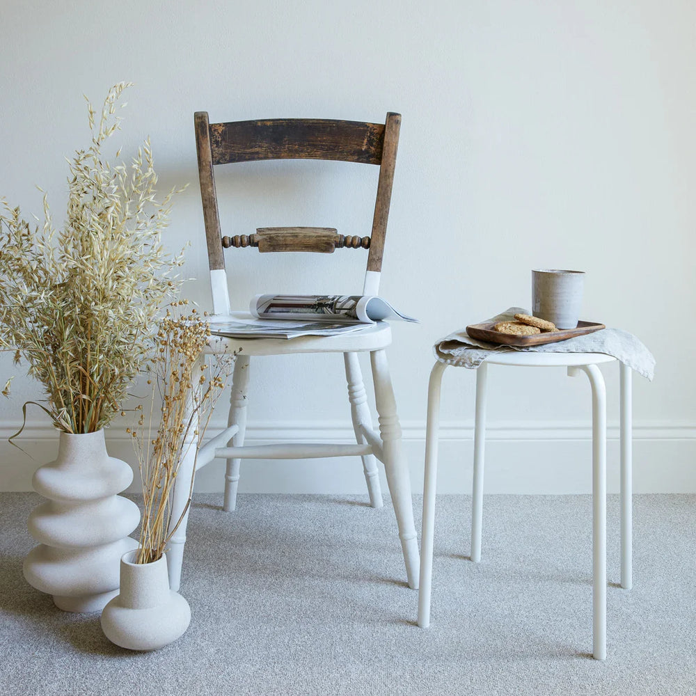 apollo plus shortbread carpet in a room with a wooden chair, white side table, and ceramic vases