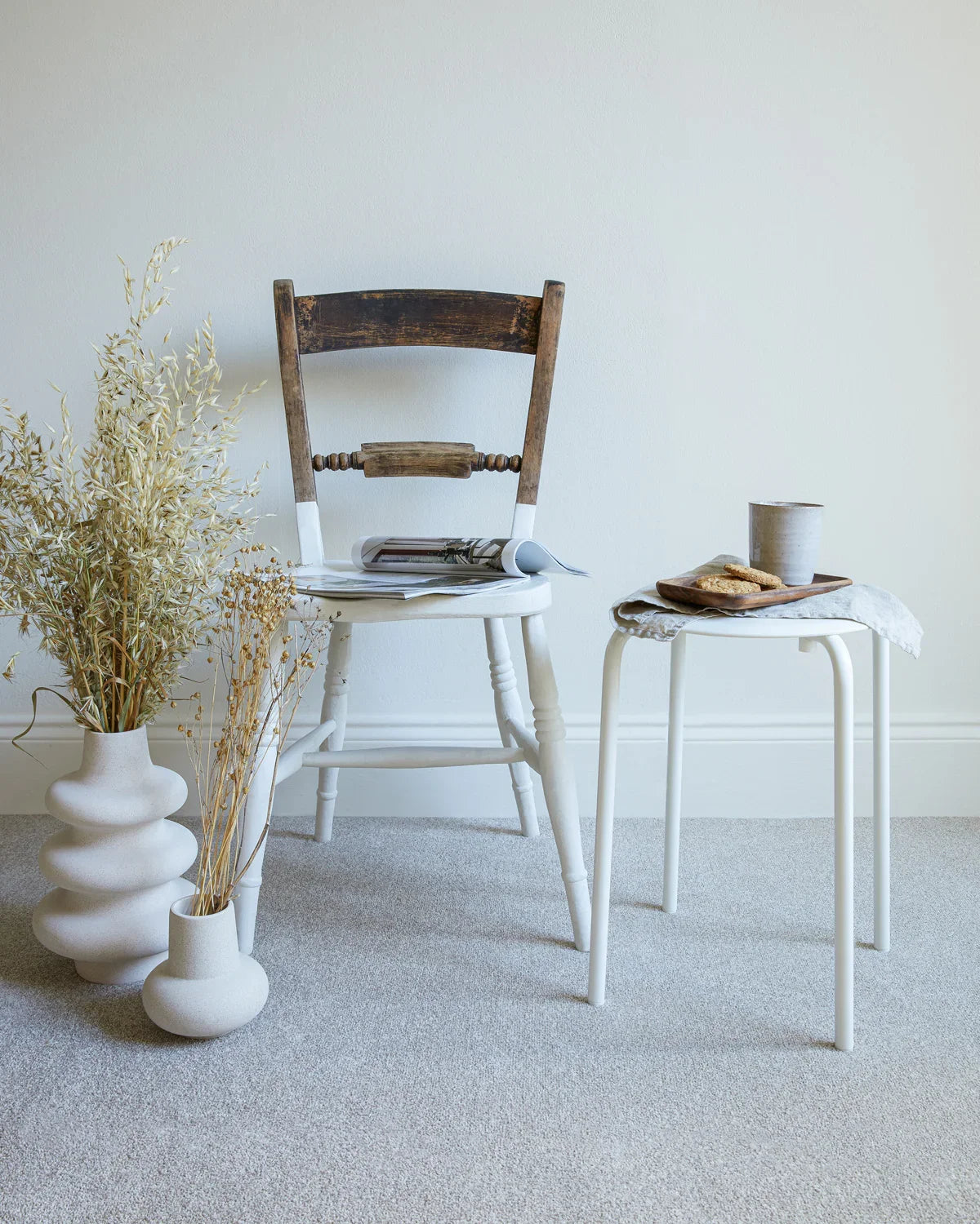 apollo plus shortbread carpet in a room with a wooden chair, white side table, and ceramic vases