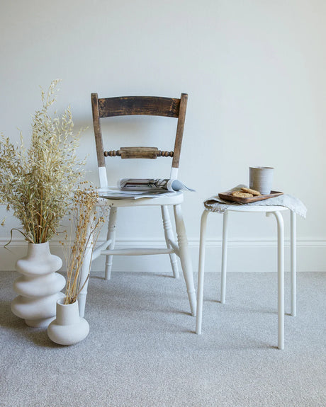 apollo plus shortbread carpet in a room with a wooden chair, white side table, and ceramic vases