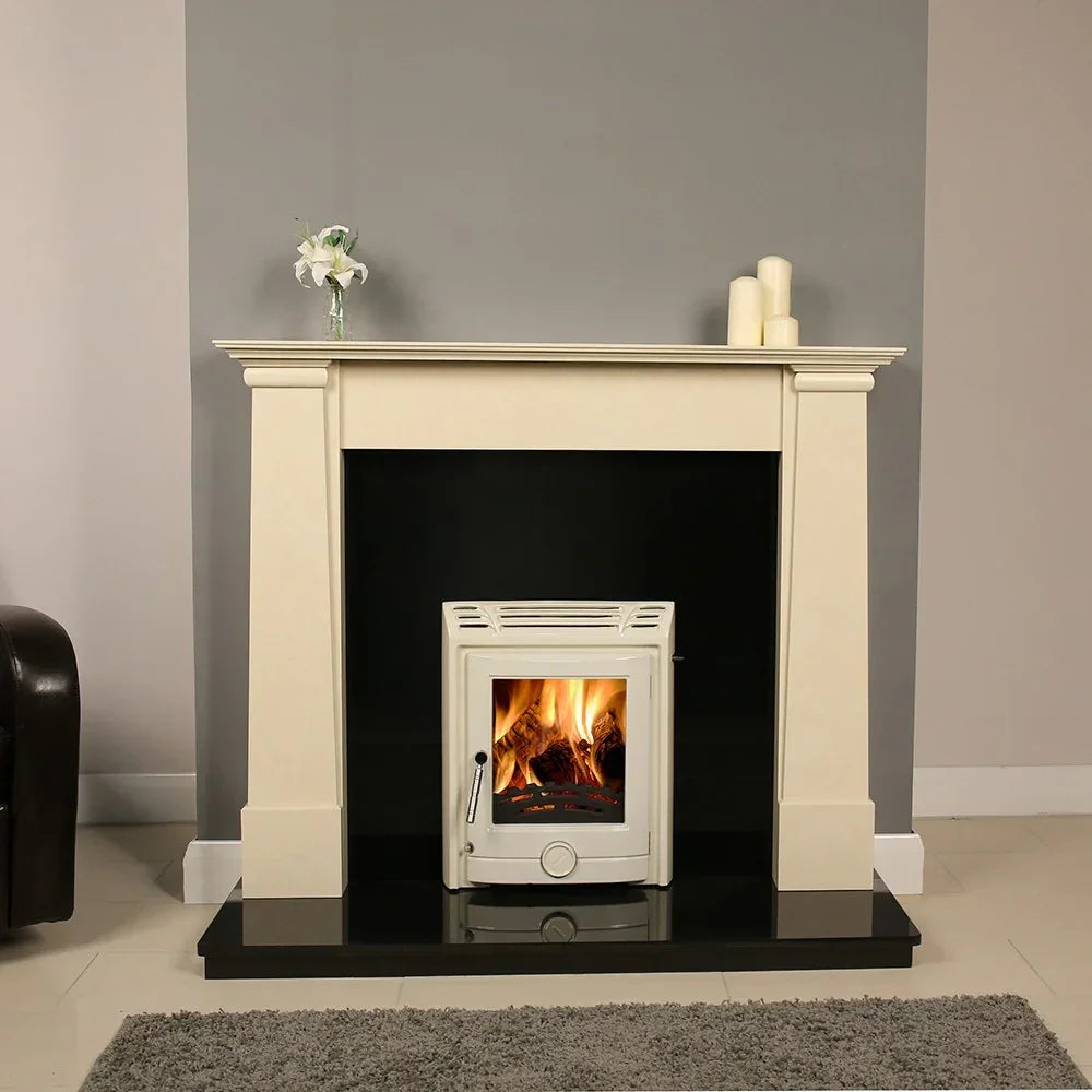 White wood-burning stove with marble fireplace surround and burning fire in living room