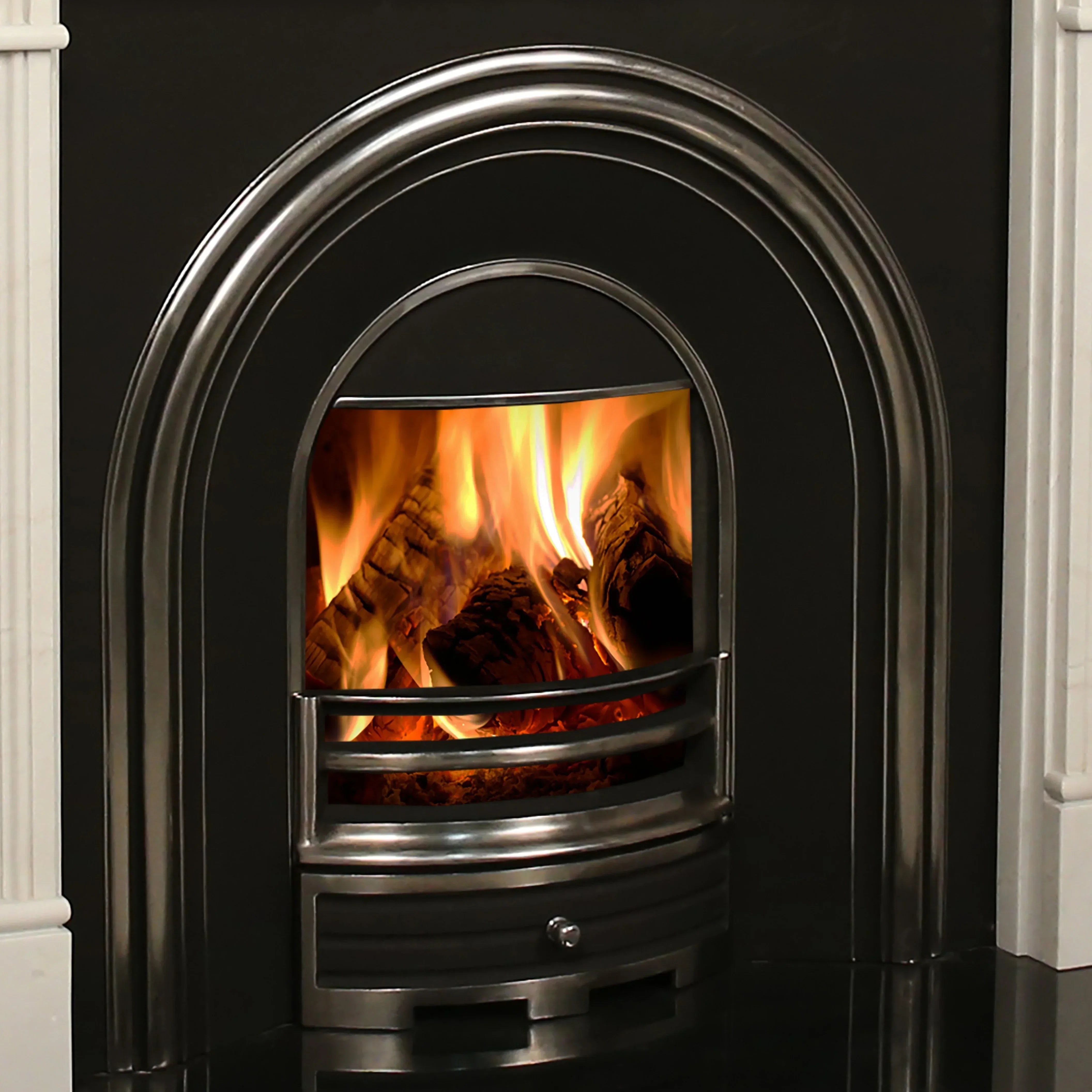 arched chrome fireplace with burning logs and black marble surround