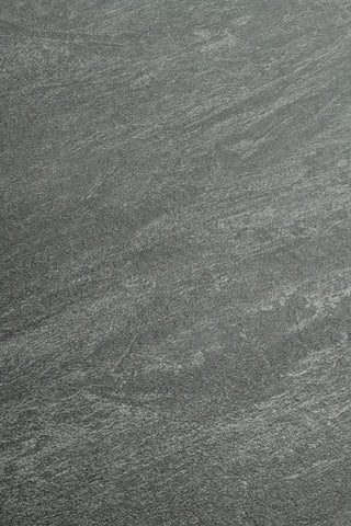 A close-up of a dark gray stone or concrete-like textured surface with subtle lighter gray veining and grain.