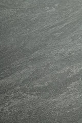 A close-up of a dark gray stone or concrete-like textured surface with subtle lighter gray veining and grain.