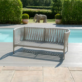 Light grey outdoor garden bench with slatted backrest by pool on patio
