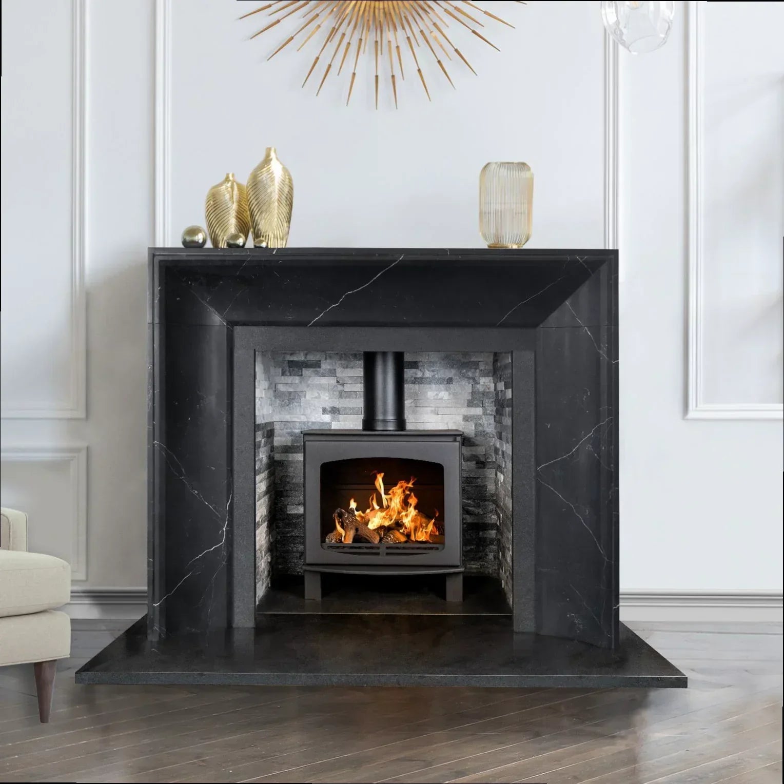 Black marble fireplace surround with lit wood burning stove and modern decor accents