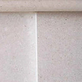 beige limestone fireplace surround with smooth textured surface and straight joint lines