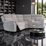 Gray sectional sofa in a modern living room with bookshelves and a coffee table.