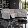 Gray sectional sofa in a modern living room with bookshelves and a coffee table.