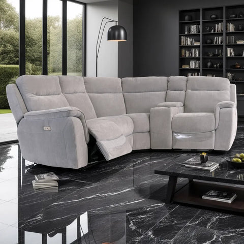 Gray sectional sofa in a modern living room with marble floor and bookshelf.