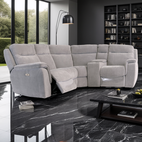 Gray sectional sofa in a modern living room with marble floor and bookshelf.