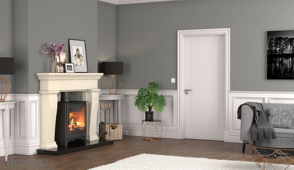 Modern living room with fireplace, grey sofa, accent table, and potted plant on wooden floor