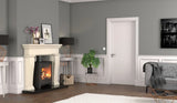 Modern living room with fireplace, grey sofa, accent table, and potted plant on wooden floor