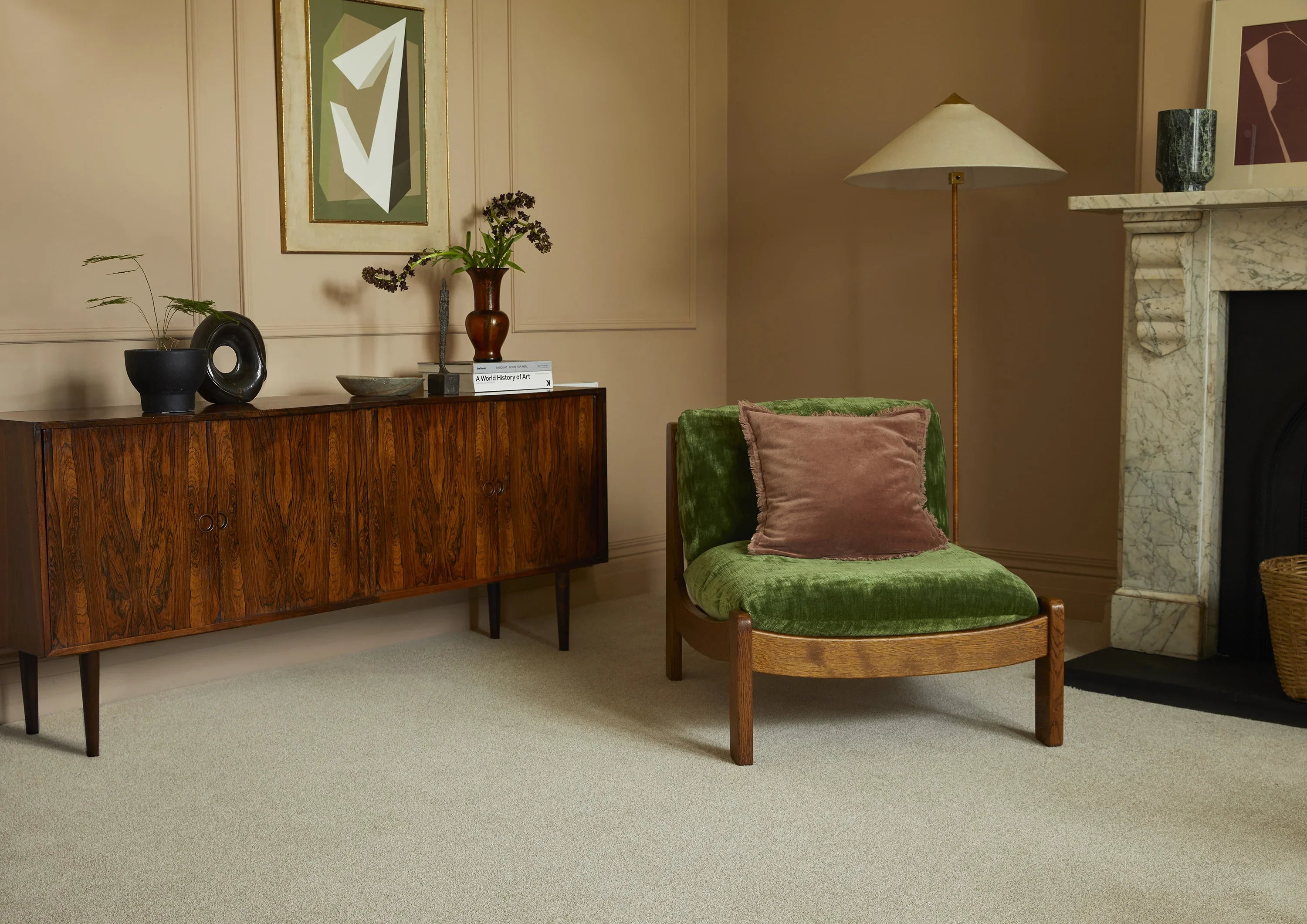 Saxony Venetian Marble carpet in lounge with green velvet chair, sideboard, and marble fireplace