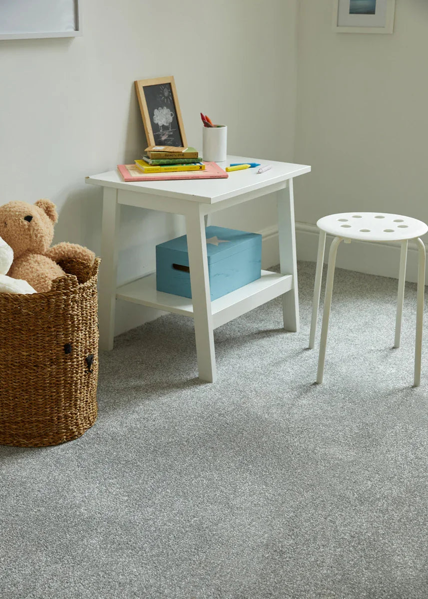 Light grey saxony carpet in kid's room with white desk, stool and wicker toy basket