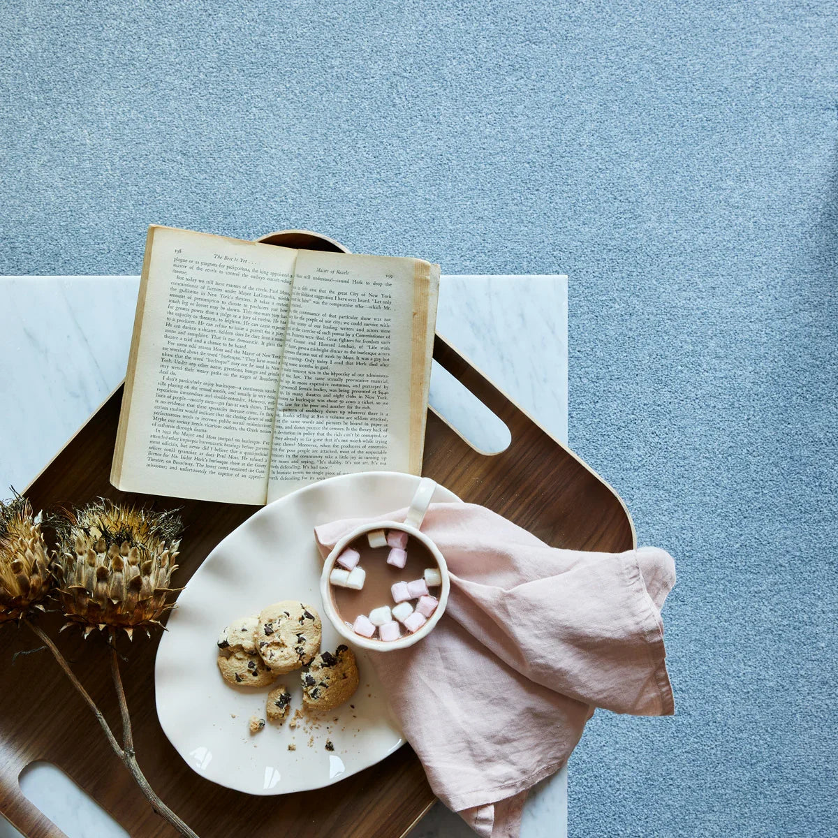 Saxony aspen blue carpet with tray, book, cookies, and hot drink with marshmallows