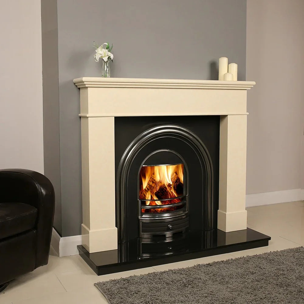 Cream marble fireplace with black cast iron insert and burning fire in modern living room