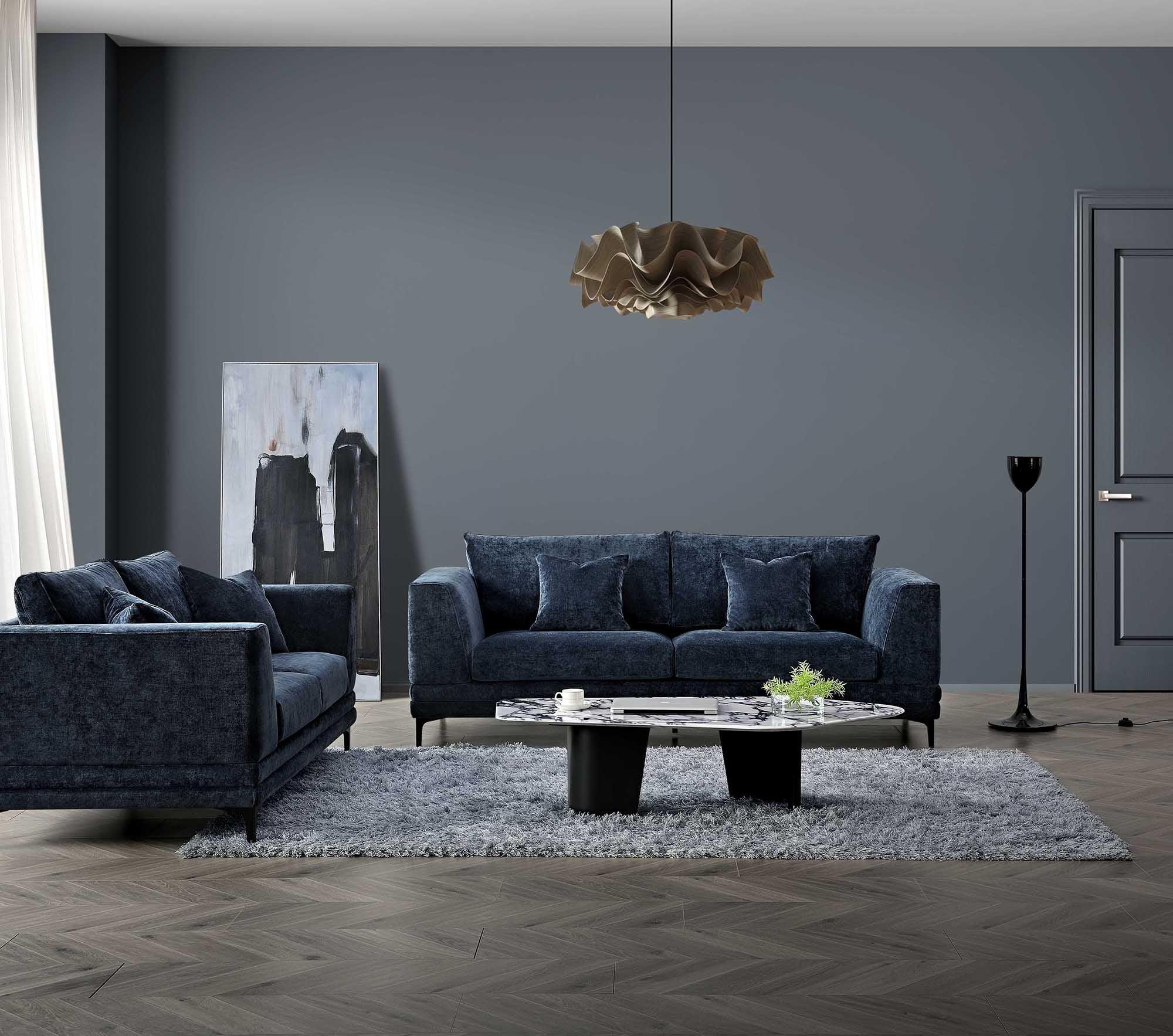 Blue fabric sofa set with matching cushions in modern living room, marble coffee table on grey rug