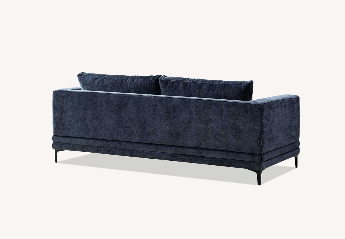 Blue fabric sofa with metal legs, rear view showing plush back cushions