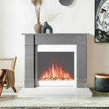 Modern electric fireplace suite with grey surround and decorative vases in living room setting